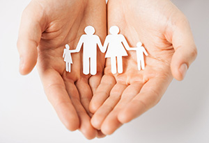 hand holding paper family